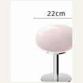 Pink Lollipop table lamp on warm off-white background