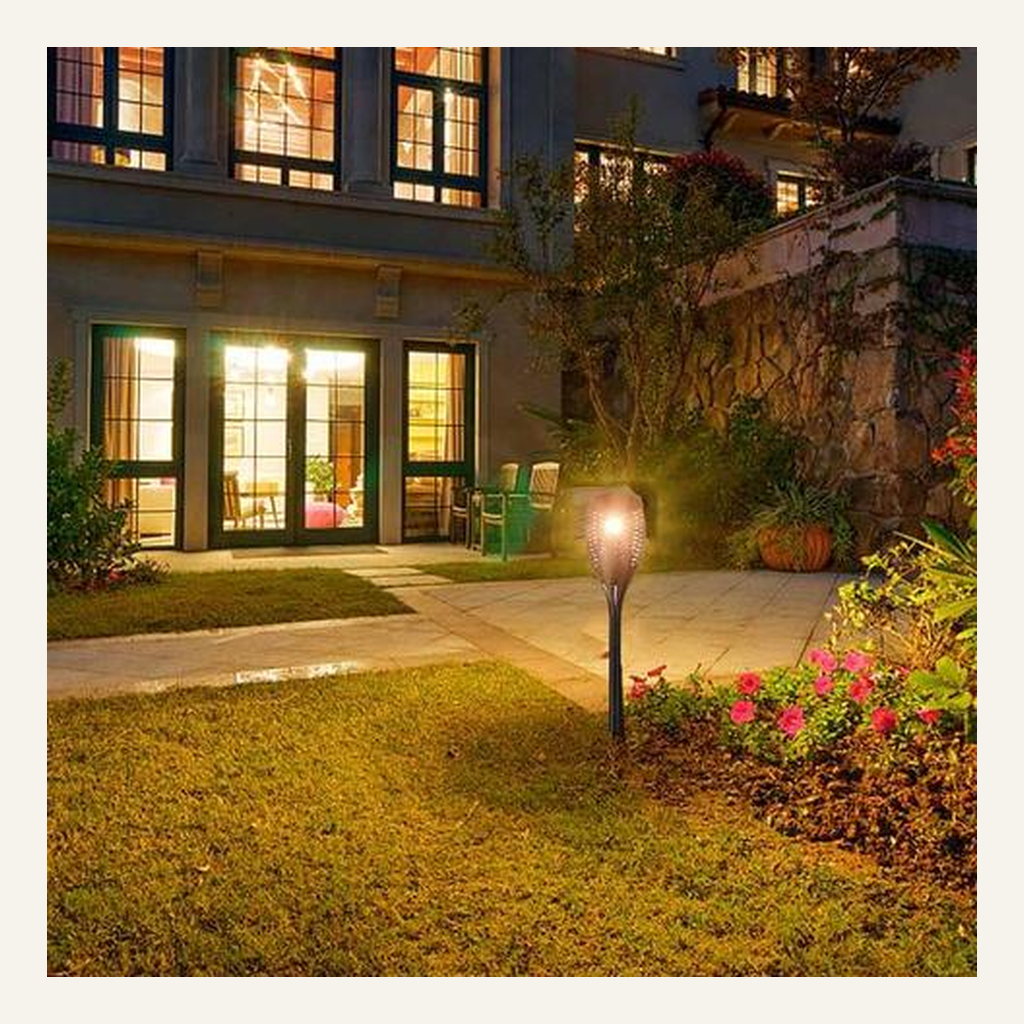 Solar flame-effect torch installed in a residential garden
