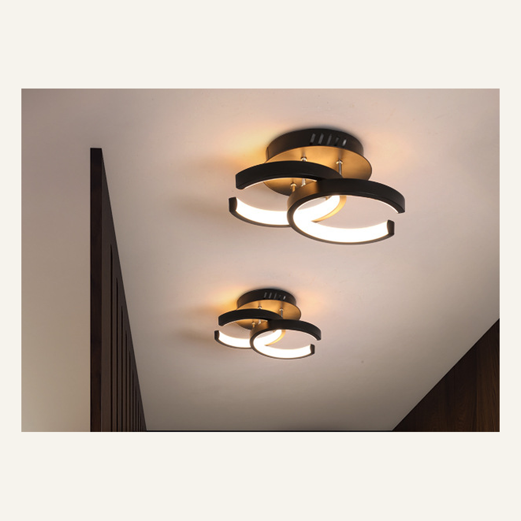 Black curved-ring LED hallway light installed on a ceiling