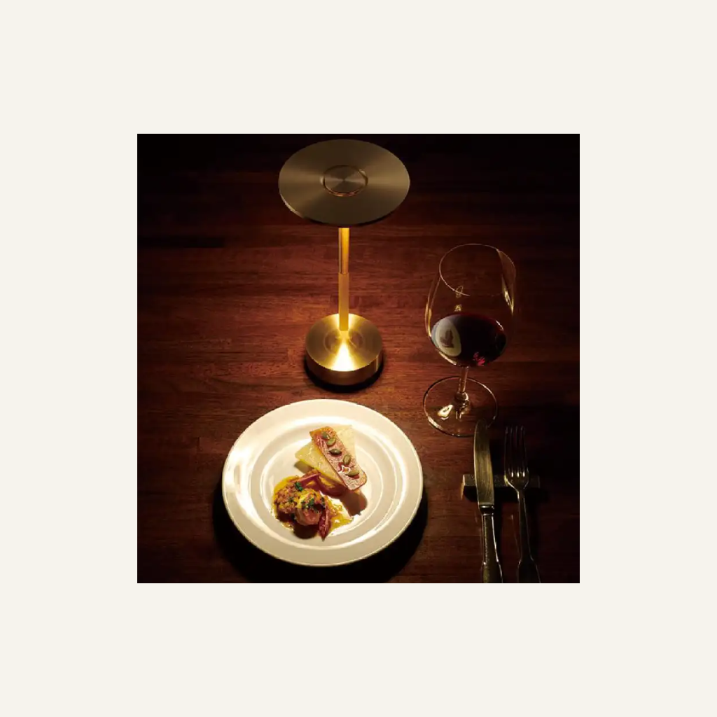 Gold aluminum table lamp in a dining setting
