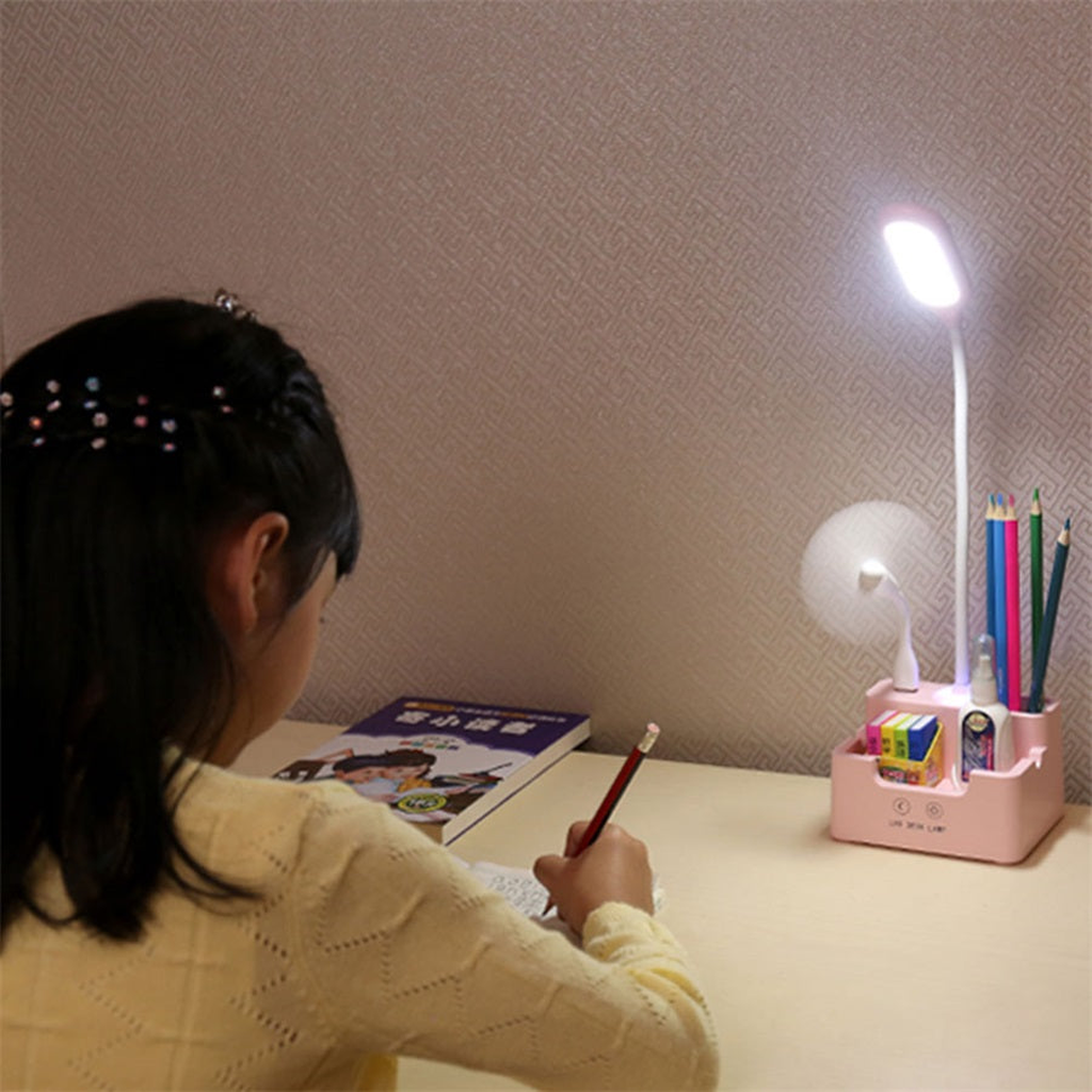 Pink LED desk lamp in use with organizer and fan