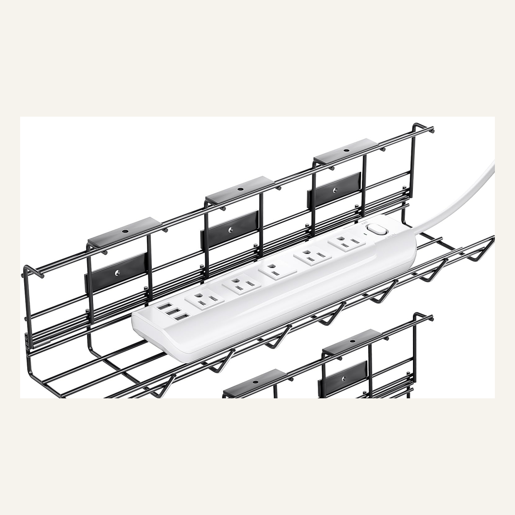 Black under-desk cable tray holding a power strip for scale