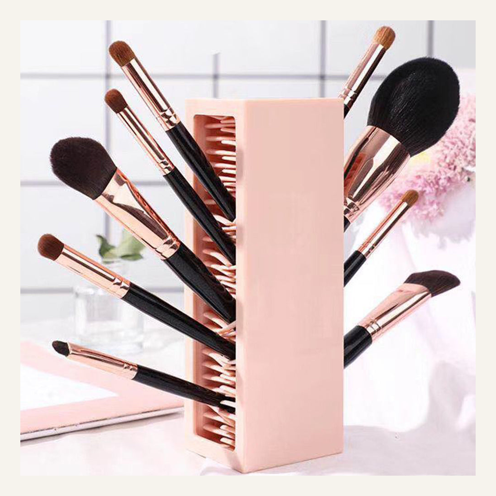 Pink makeup brush organizer in a vanity setting