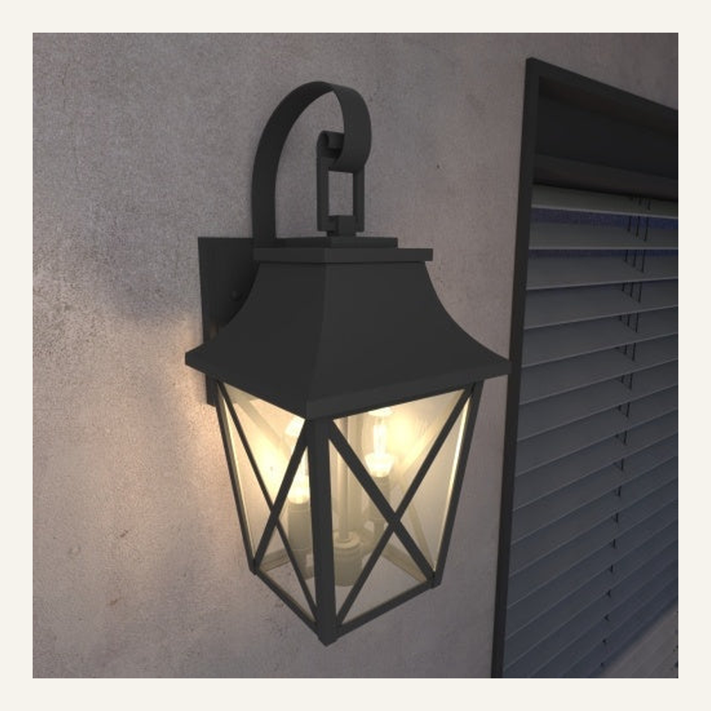 Black outdoor wall lantern installed beside a window at dusk