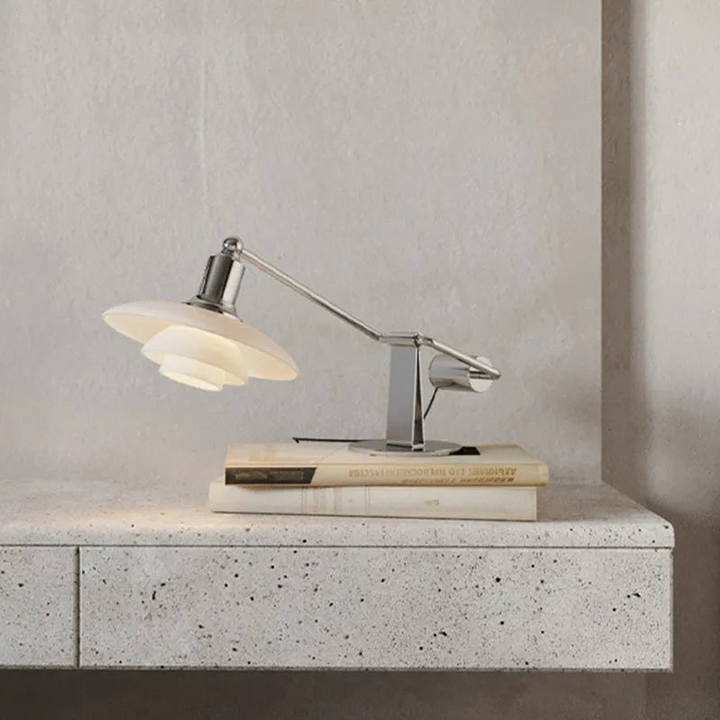 Chrome glass desk lamp in a desk setting