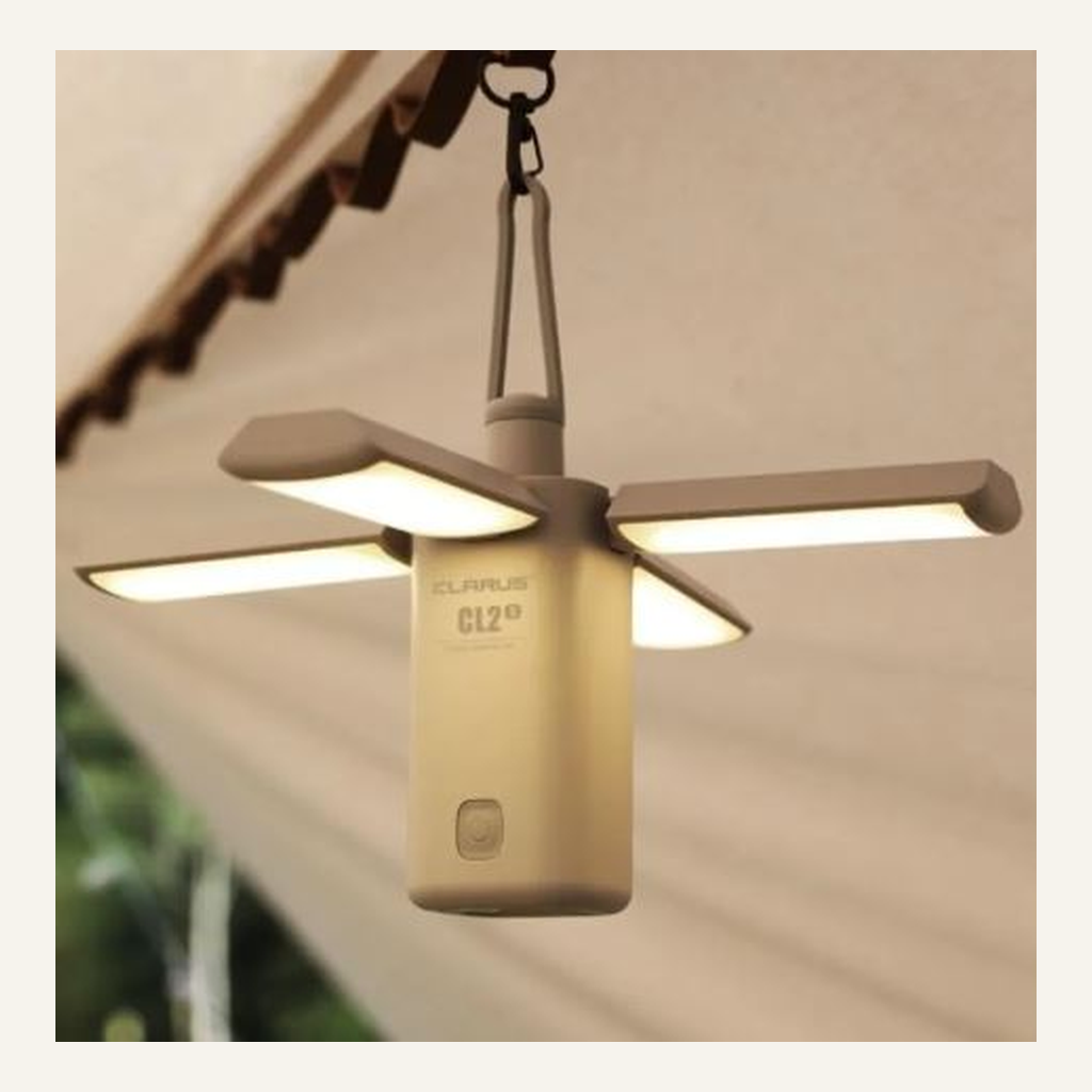 White folding camping light deployed in a tent