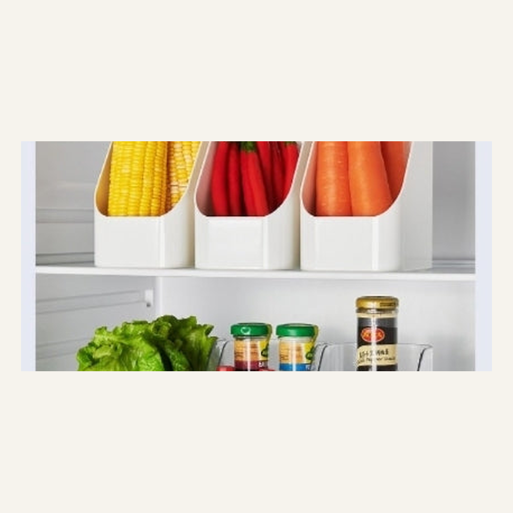 White storage boxes organizing produce in a refrigerator