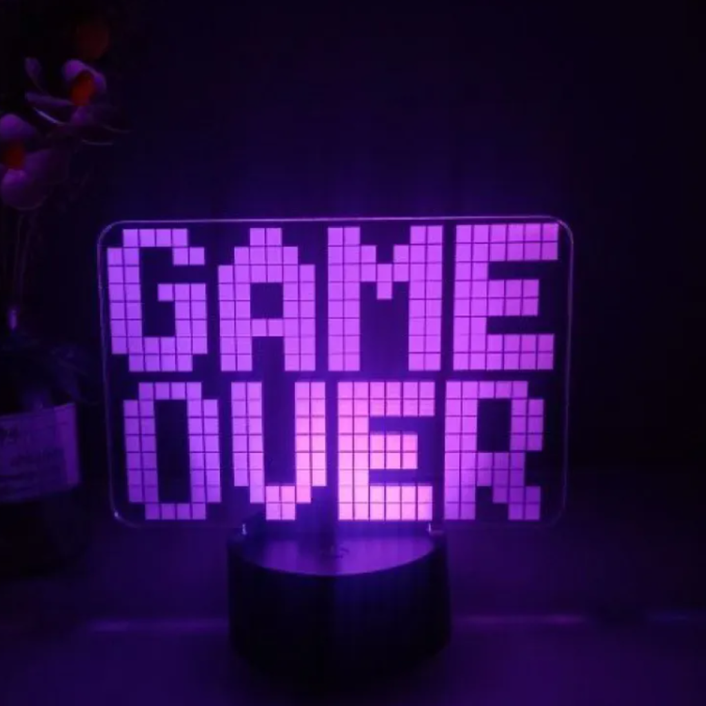 GAME OVER LED desk lamp with black base in a low-light setting