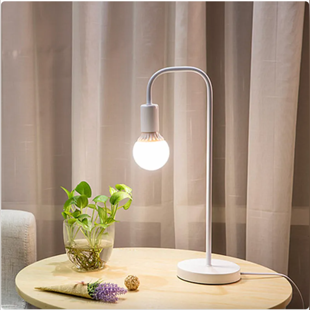 White curved-arm table lamp with white base