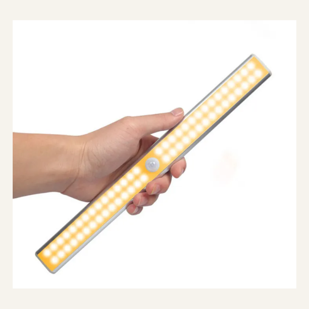 Silver rechargeable cabinet light shown in hand