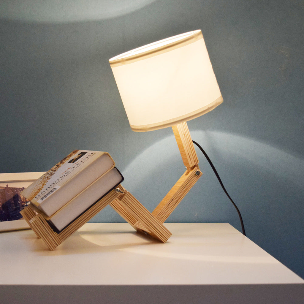 Wooden adjustable lamp positioned over books