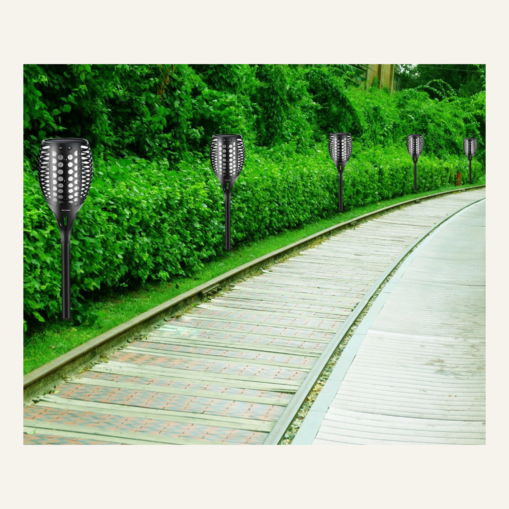 Solar flame-effect torches lining a garden path