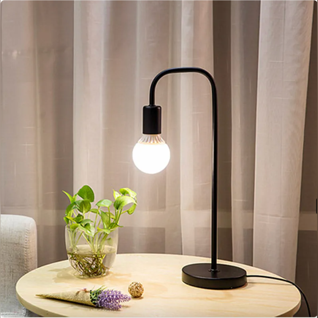 Black curved-arm table lamp with black base